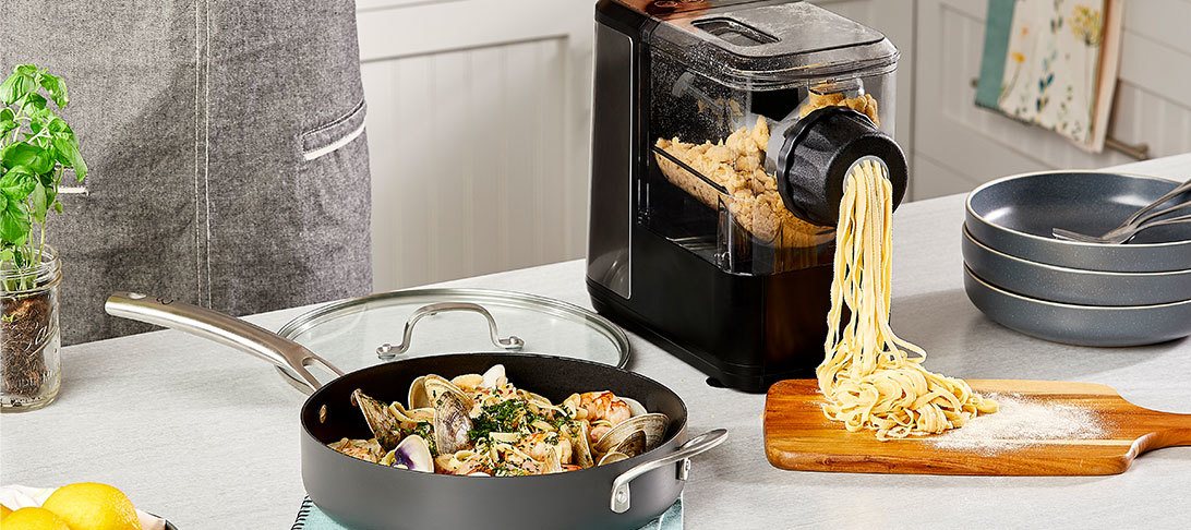 Person making Pot of seafood linguini in the pasta maker