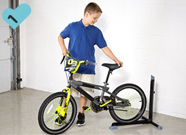 Boy backing his bike into the Bike Nook
