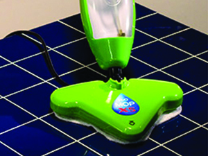 Steam cleaning a blue tile floor