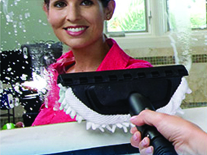 Cleaning a mirror with the glass and window tool