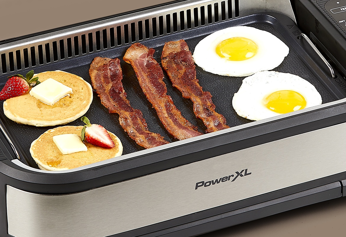 griddle plate with bacon, eggs, pancakes